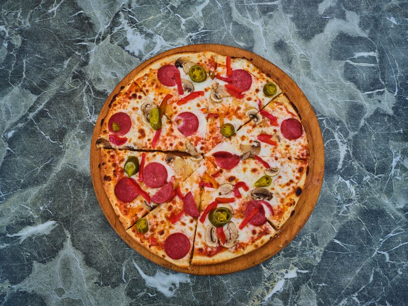 Marco's Classic Margherita Pizza with fresh basil and mozzarella